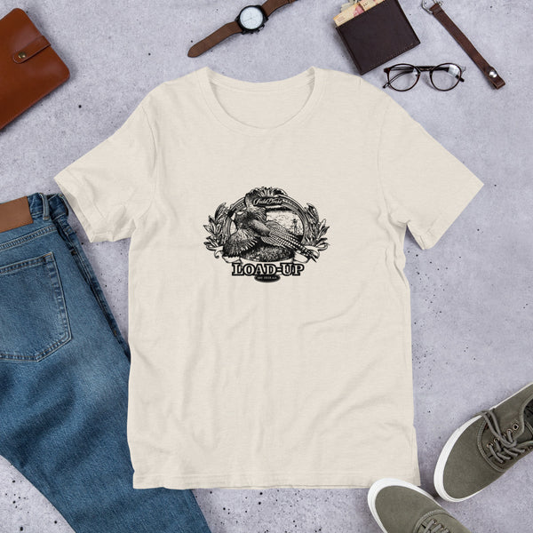 Field Dress pheasant hunting t-shirt shows a flushed pheasant and a distant hunter taking aim, the phrase "load-up", and the established date of firearms 1515AD.